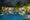 view at night of the pool at maison vy with a bar lit up in the back and trees around the pool