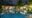 view at night of the pool at maison vy with a bar lit up in the back and trees around the pool
