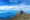 view of the peak of Mount Kinabalu, Borneo in a distance with blue skies above