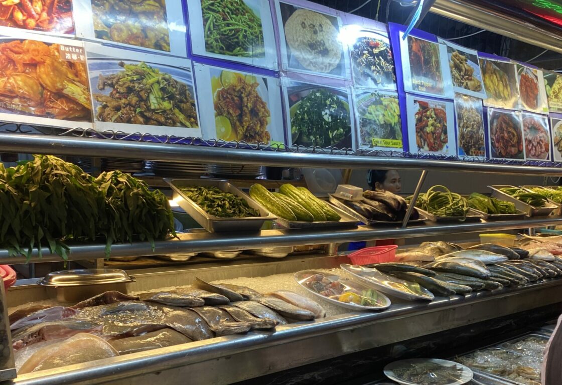 Bornean food featuring curries, rice, chicken skewers - Borneo