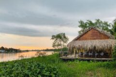 waterfront restaurant at mango riverside hut overlooking the river at sunset