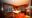 twin bedroom at Abai Jungle Lodge featuring wooden features, twin bed, curtains, wall decorations