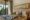 spacious bedroom with wall decoration with a text saying Utan Rainforest lodge, private balcony