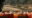 Flame of the Forest in india a table lined with orange cloth and filled with cutlery and plats with a river view in the background