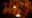 Flame of the Forest IND plate of dumplings in the dark with candles on the table