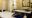 two spa beds with blue cushions face open curtains and a plunge pool in the corner and mirror on the wall with a small sink underneath