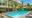 Viroth's Hotel in Cambodia with sun loungers and a building that has tables and chairs outside