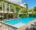 Viroth's Hotel in Cambodia with sun loungers and a building that has tables and chairs outside