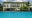 Viroth's Hotel pool with a white building behind that has greenery growing from the roof