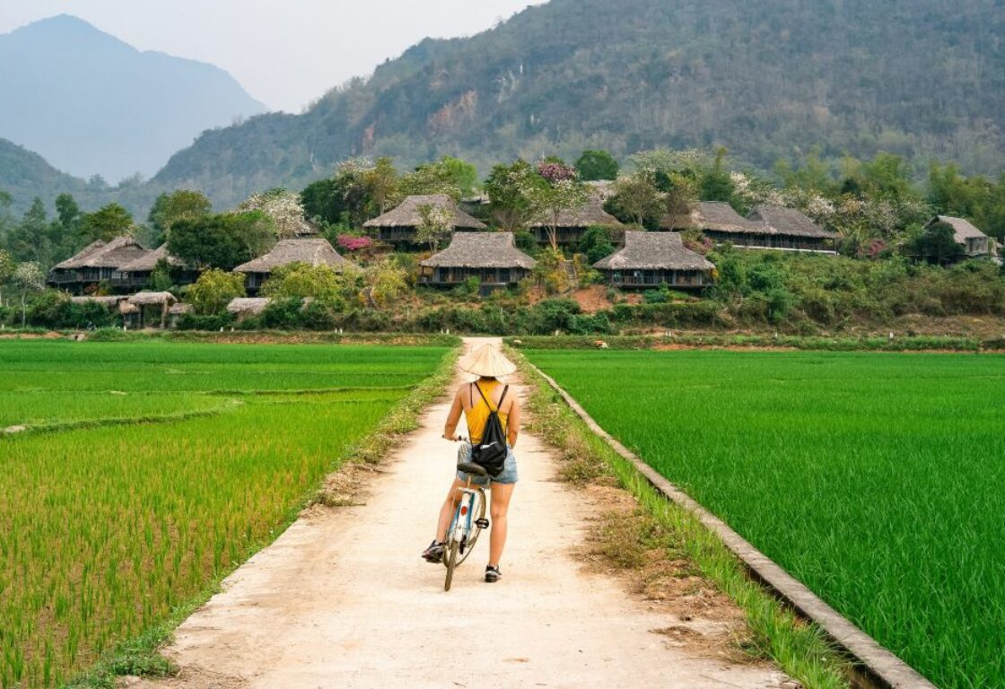 woman cycling in mai chau vietnam