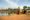 father of two sons and daughter sat together with angkor wat in the distance, cambodia
