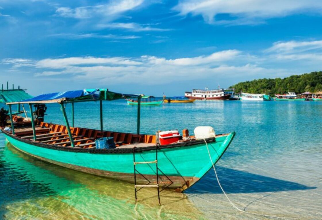 wooden boat in the shallow crystal clear water in cambodia