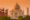 orange sunrise over The Taj Mahal in india, a white marble mausoleum with a large central dome and four minarets