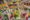 rows of square offerings line along the floor and each one contains a variety of petals and herbs and colourful flowers
