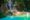 the kuang si waterfalls cascading down through tropical jungle, into a large turquoise blue pool at the bottom in laos