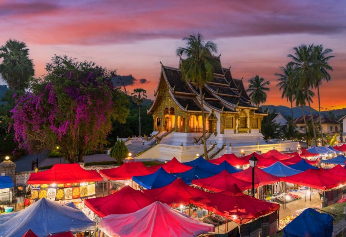 colourful tents infront of a temple in luang prabang, laos