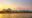 sunset over mountains and a river in vang vieng