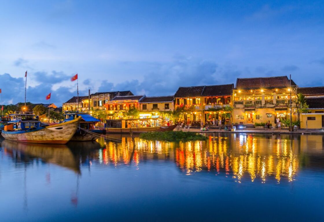 evening on the thu bon river with lights reflecting in the water