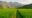 green paddy fields and mountains in the background in mai chau, vietnam