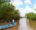 fisherman on a quiet part of the mekong delta in vietnam floating down the river with no one else around in a long blue boat
