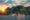 sunset in ha long bay with cruise boats moored