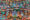 detail of a temple with lots of blue, orange and green buddhist statues