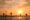 Galle stillts fisherman perched in the sea at sunset