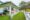 front building at Ashburnham Estate - white bungalow with green area surrounding it