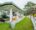 front building at Ashburnham Estate - white bungalow with green area surrounding it