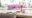 dining area outdoors with table with flowers and pink bushes in the back ground