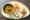 plate filled with traditional curry, bread and rice