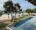 Lantern Boutique Hotel view over the pool and ocean with palm trees