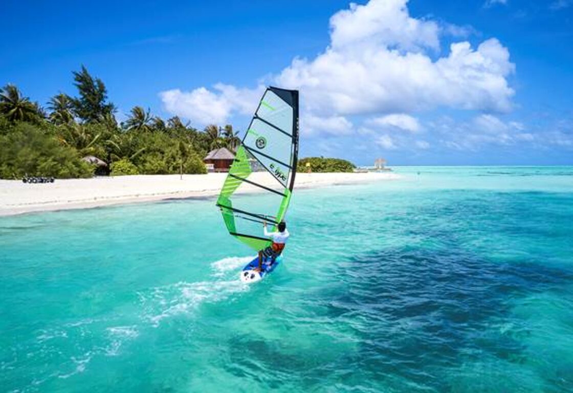 a person windsurfing on the crystal clear waters in Maldives