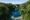 pool surrounded by lush green forest at Cinnamon Wild Yala
