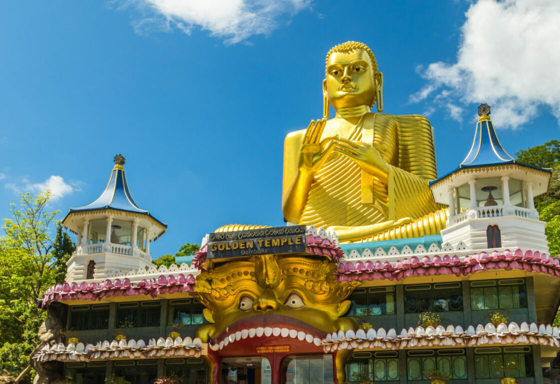 gold large budha sitting atop a temple in Dambulla