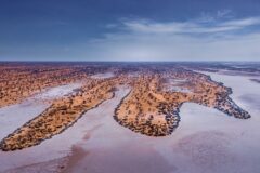 and aerial view of the kalahari desert with sand and random green savannah ibetween
