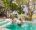deluxe room with a private plunge pool with a couple having a swim overlooking the african bush