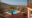 a small pool built into a wooden deck platform with several loungers around it, plant pots all high up overlooking the african bush