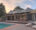 side angle of a tented lodge with a pool in front of it at sunset
