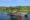 a group of people are on a river boat enjoying a cruise looking for a wildlife