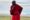 maasai warrior standing on top of the rock overlooking Olduvai plains in Tanzania