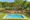 Aerial view of the large inviting swimming pool and gardens at the Rissington Inn.