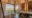 luxury bathorrom with a bathtub, huge windows overlooking the bush, sink and a mirror