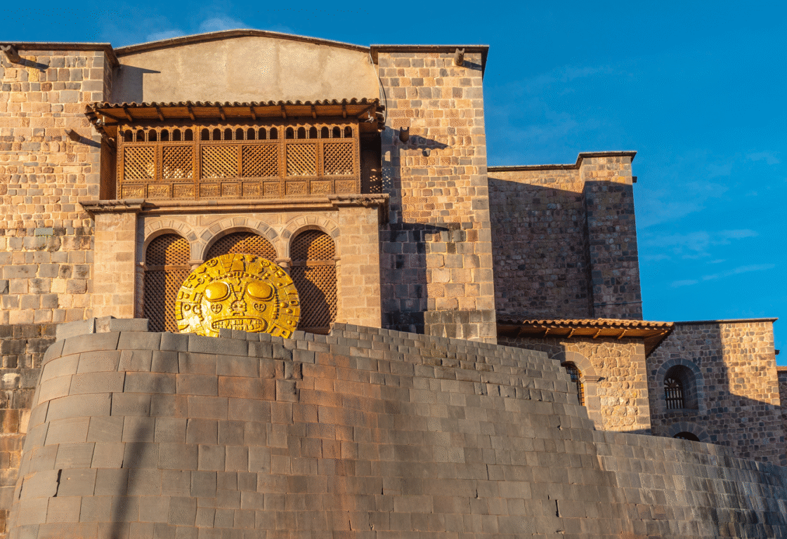 Panoramic photograph of the inca sun temple or Qorikancha in Cusco city during Inti Raymi, hence the solar disk. Famous for its inca wall stonework and Santo Domingo convent built on top, Cusco, Peru.