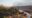 a person biking in the distance through the surrounding mountainous area of Rio Perdido