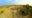an aerial view of a safari lodge and a water hole