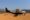 coastal air light aircraft standing on a red sand airstrip in Africa