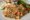 a plate of mixed rice or cous cous with vegetables, asparagus and wedge of lemon