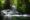 mini waterfalls in river surrounded by lush tropical greenery