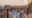 a table with white table cloth laid with alcoholic bottles and glasses to make traditonal sundowner drinks, all set on a wooden terrace high up overlooking the sunset in the bush